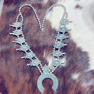 Gorgeous squash blossom turquoise and sterling silver.